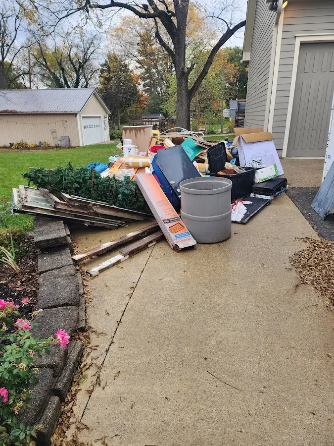 Dumpster being loaded with debris for Estate Cleanout Dumpster Rental in Big Spring